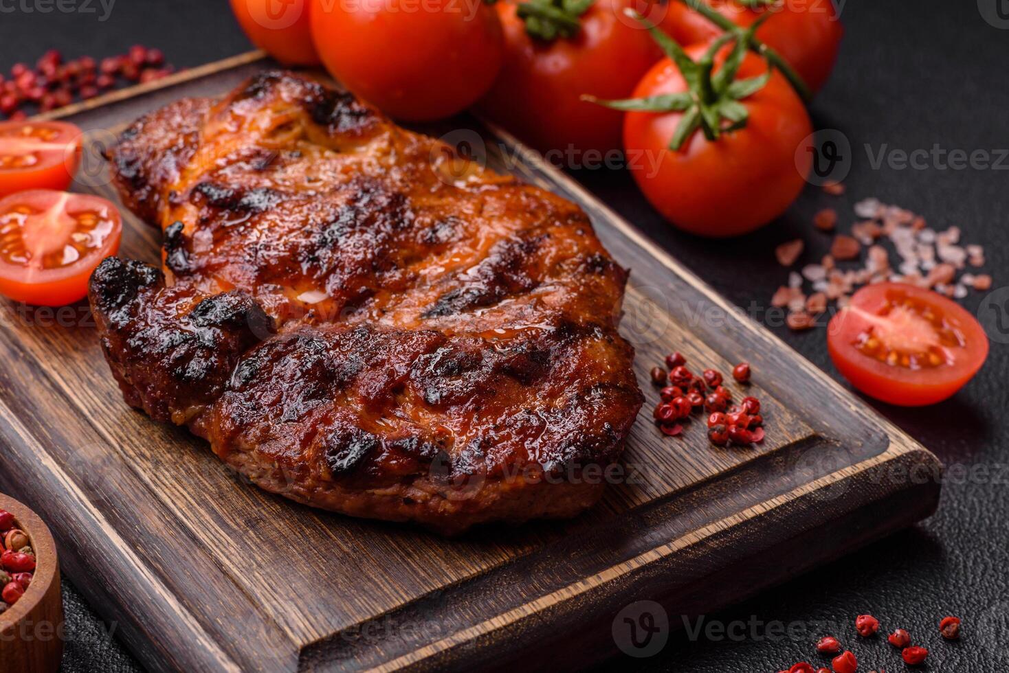 Fresh juicy delicious beef steak on a dark background photo