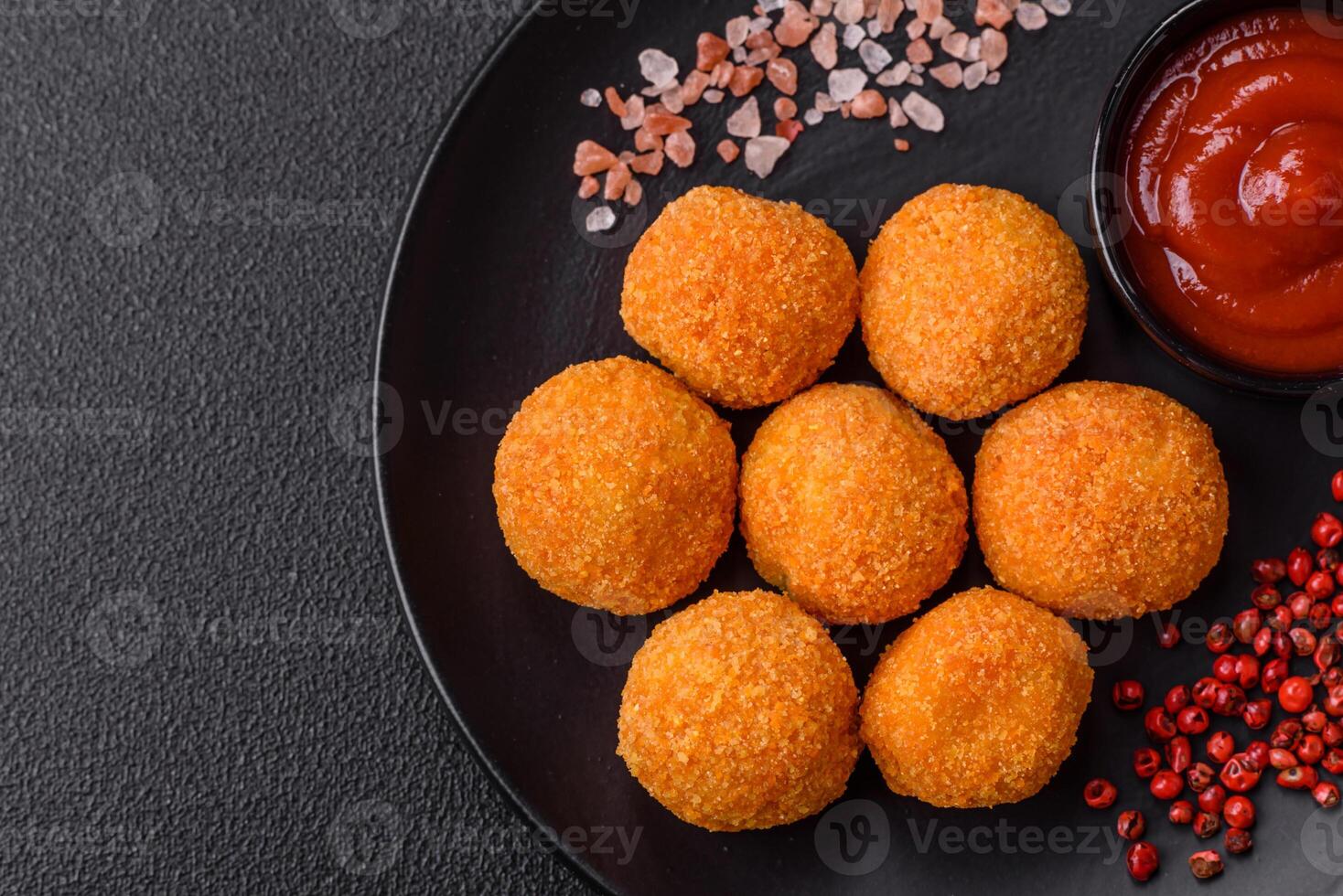 Delicious  balls of mozzarella and parmesan cheese with salt and spices photo