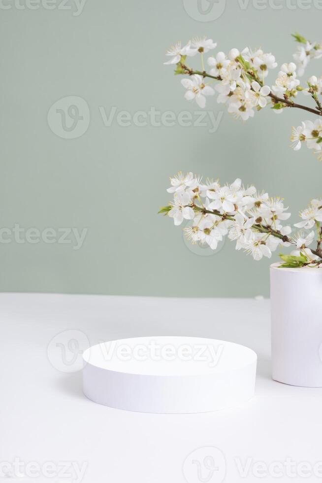 Empty podium or pedestal with spring bloom. Mock up for cosmetic products photo