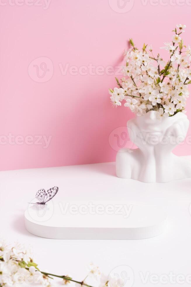 Empty podium or pedestal with spring bloom. Mock up for cosmetic products photo