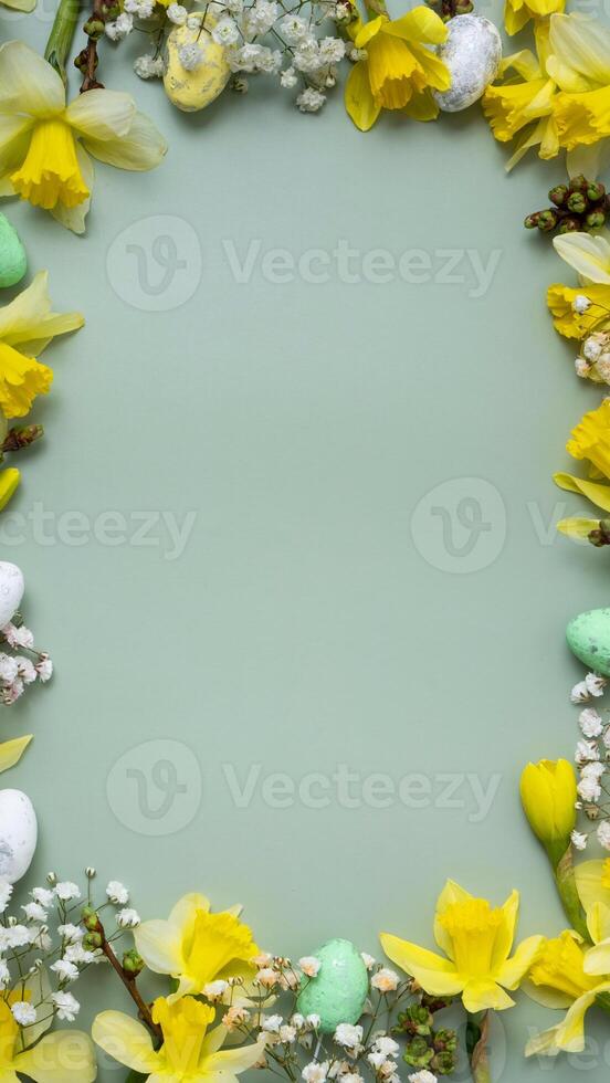 Spring flowers ans easter eggs border on green background with copy space. Easter greeting card photo