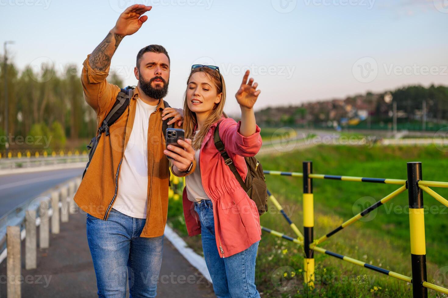 Adult couple are using maps on smartphone in the city. Tourists are sightseeing in the city. photo