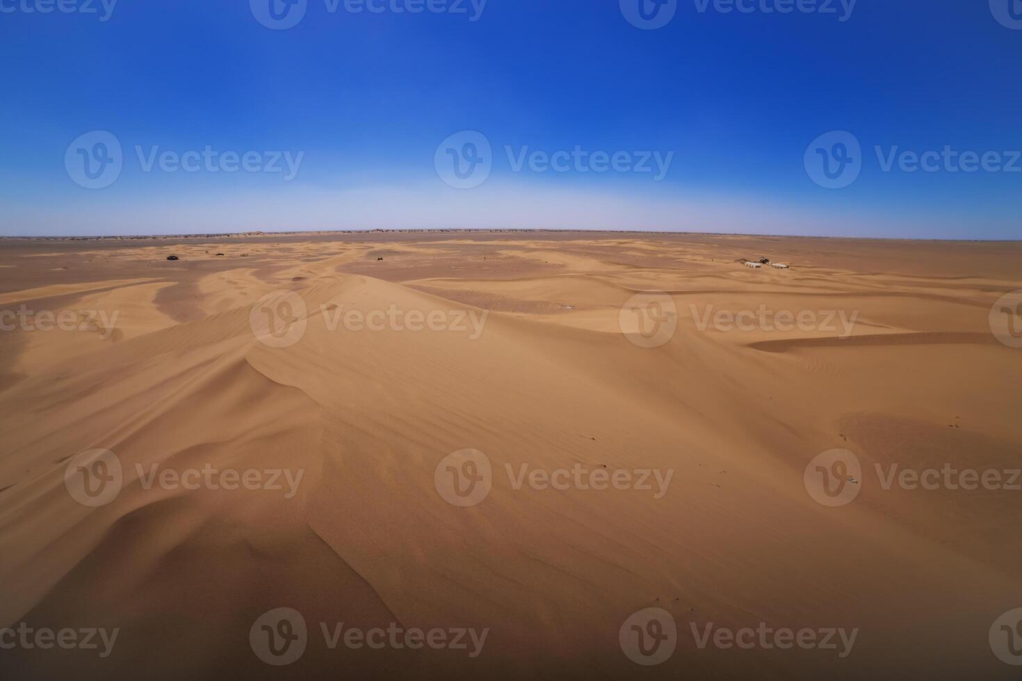 A panoramic sand dune of sahara desert at Mhamid el Ghizlane in Morocco wide shot photo