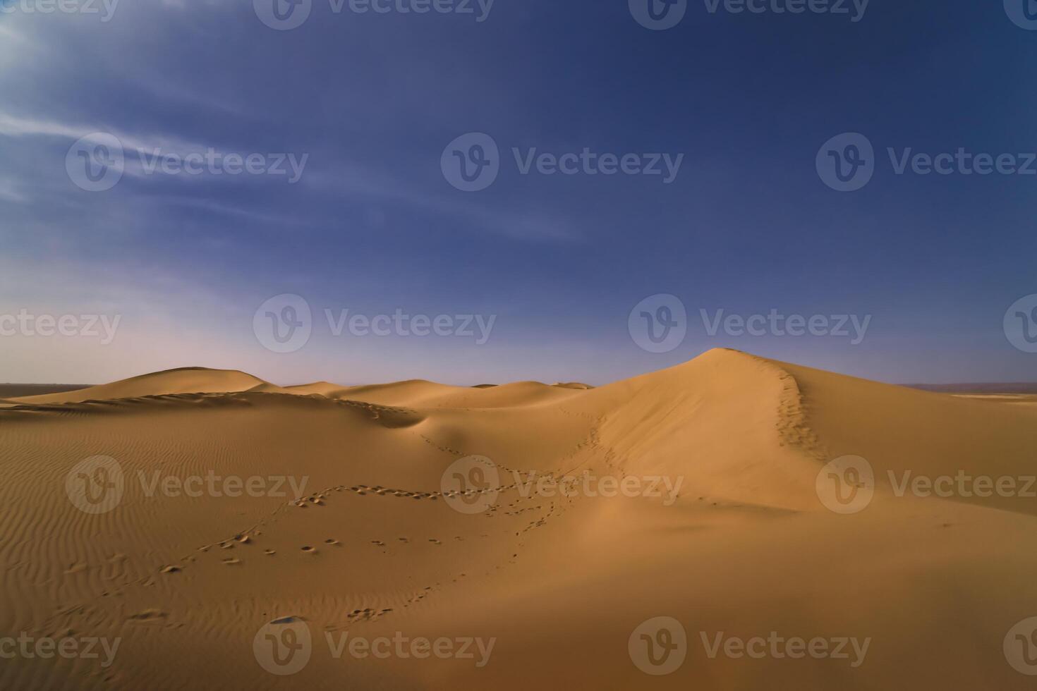 A panoramic sand dune of sahara desert at Mhamid el Ghizlane in Morocco wide shot photo