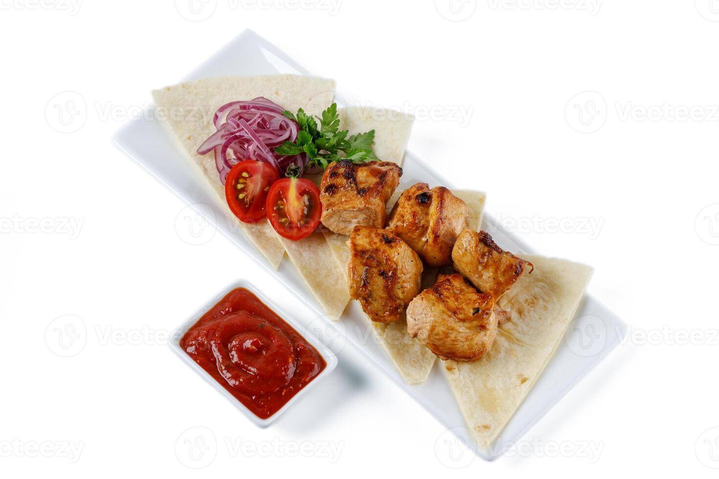 Chicken kebab skewers on a plate over light grey slate, stone or concrete background . Top view with copy space.1 photo