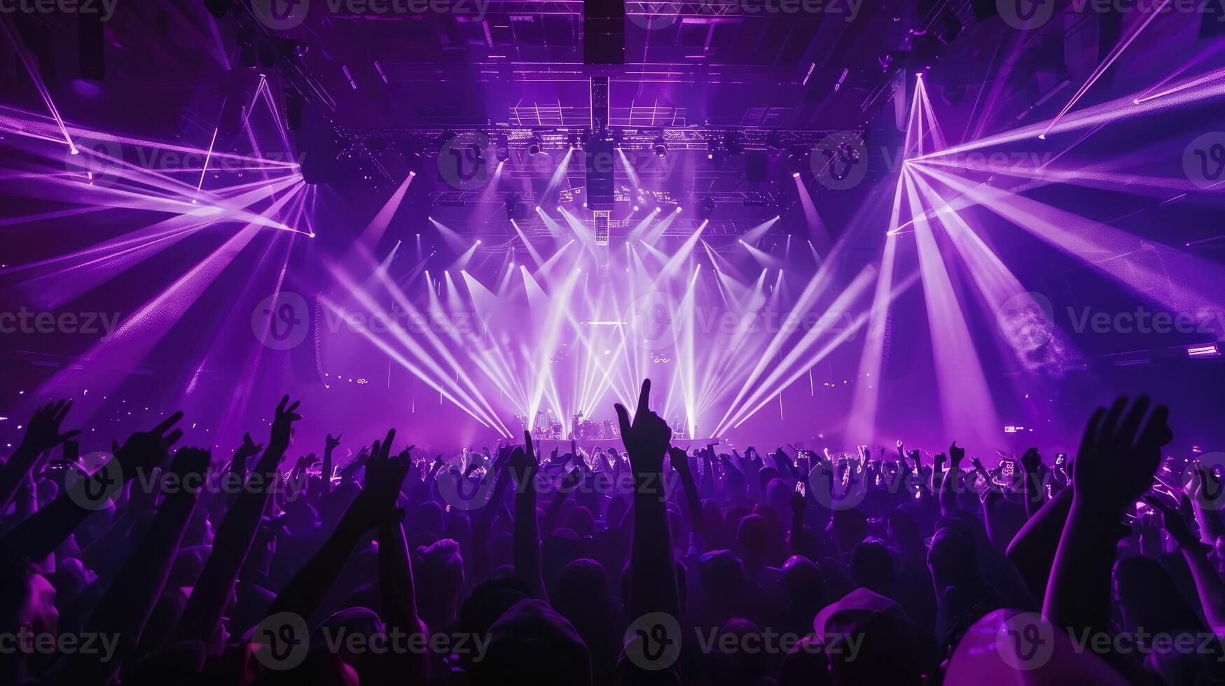 Arena or Stadium concert with center stage, illuminated with purple lasers photo