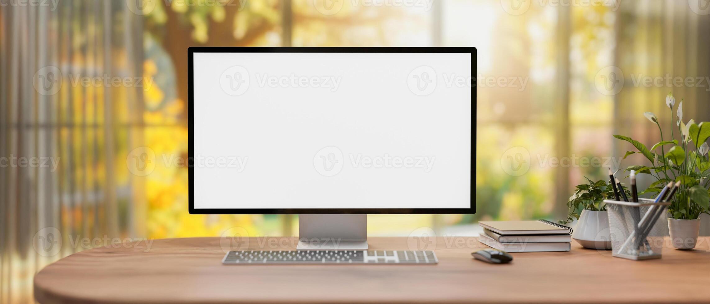 A computer mockup on a desk in a modern home office with a large window with a beautiful garden view photo