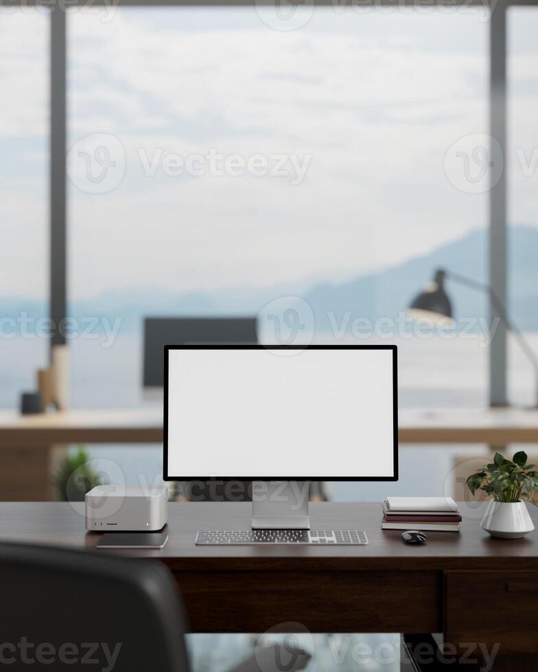 A white-screen computer mockup on a desk in a modern spacious office with a beautiful nature view. photo