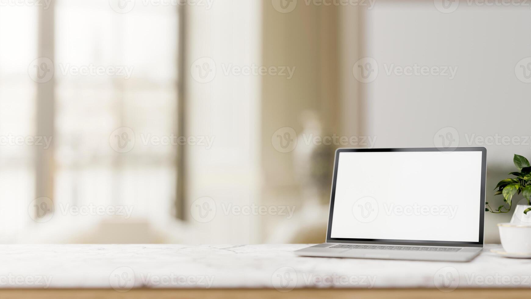 A white-screen laptop computer mockup is placed on a luxury white marble tabletop in a modern room. photo