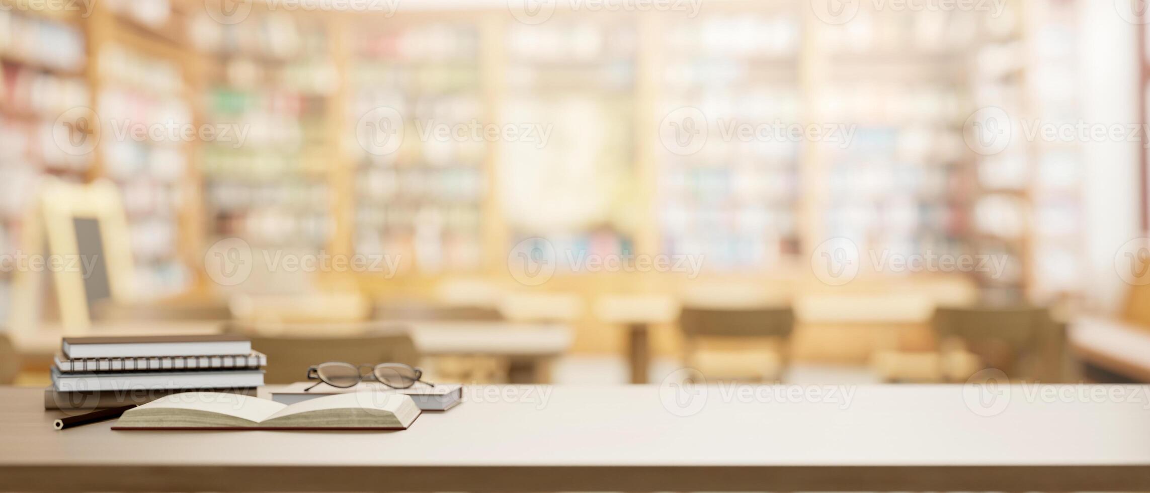 A wooden table features eyeglasses, books, and a presentation space in a school library. photo