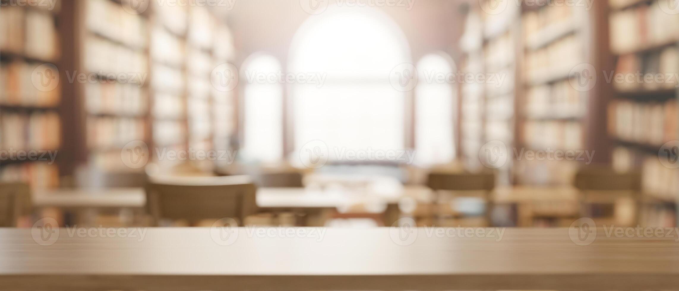 A presentation space on a wooden table with a blurred background of a spacious vintage library. photo