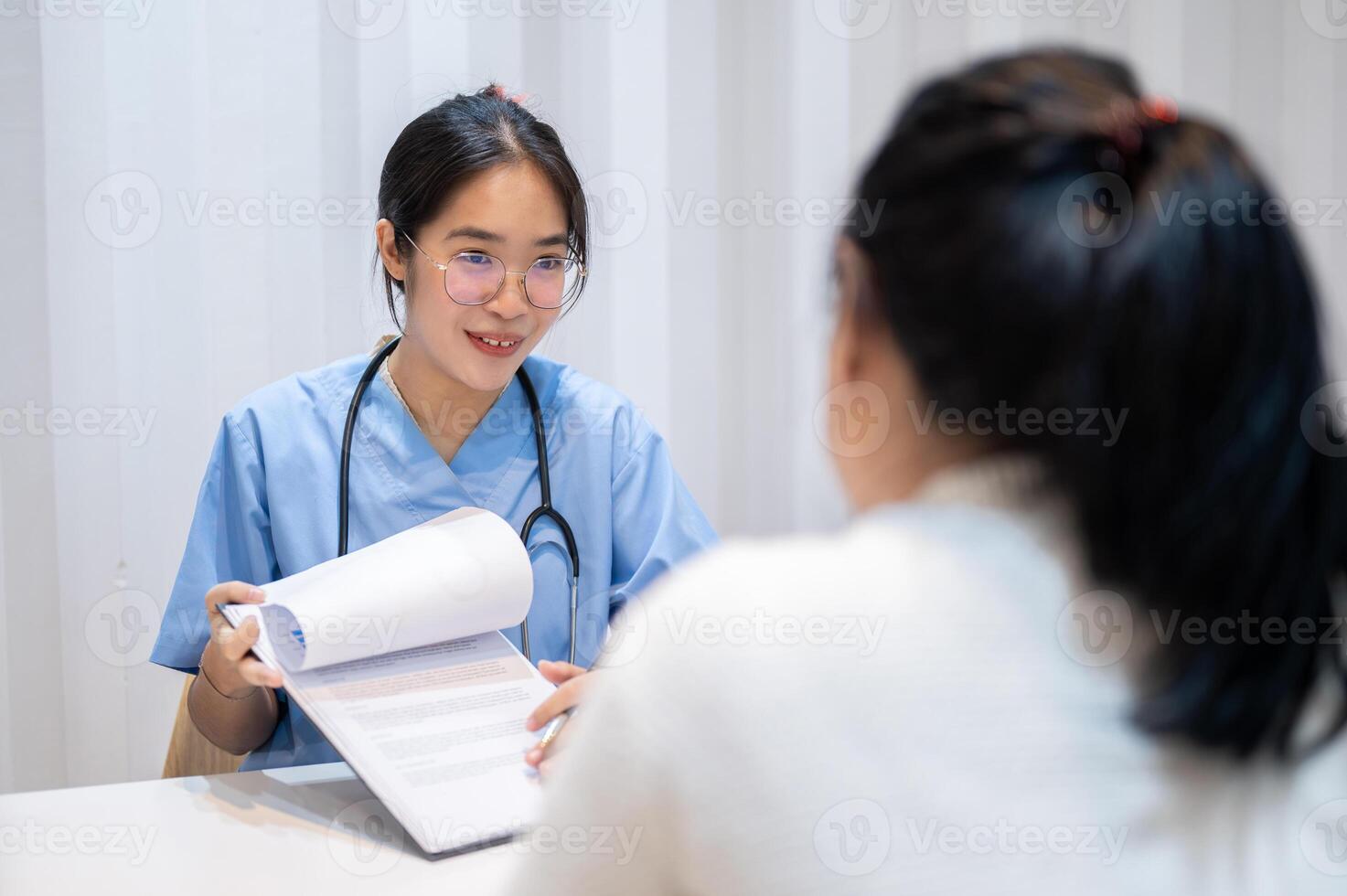 A doctor showing reports and giving advice to a patient during a medical check-up at the hospital. photo