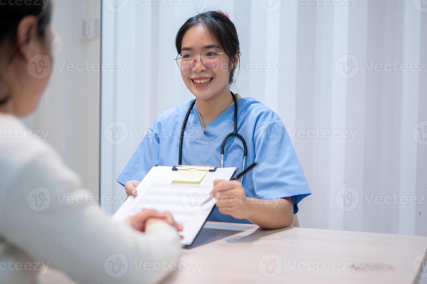 A doctor explaining a medical insurance claim document to a patient during a meeting in the office. photo