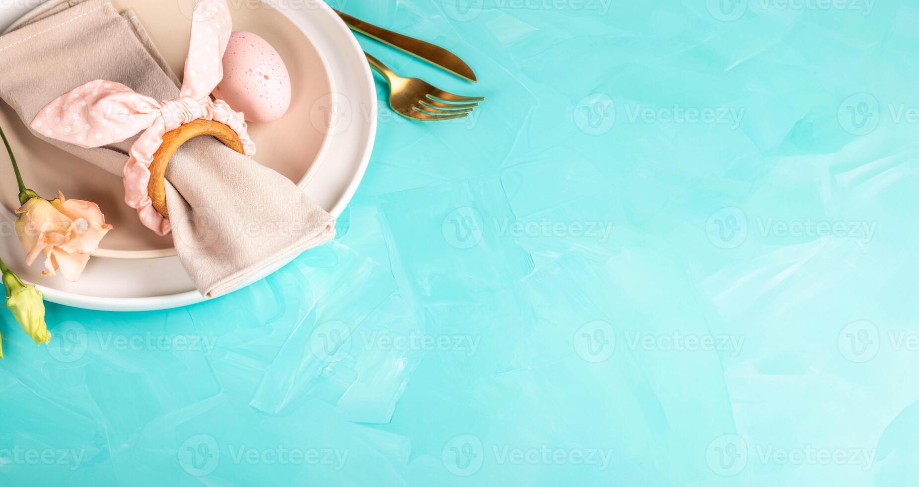 Easter serving in pastel pink peach colors on turquoise. Horizontal format. Copy space. photo