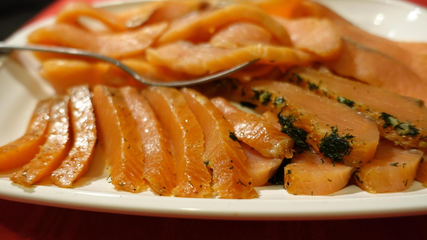 Seasoned and smoked salmon fillet sliced and served photo