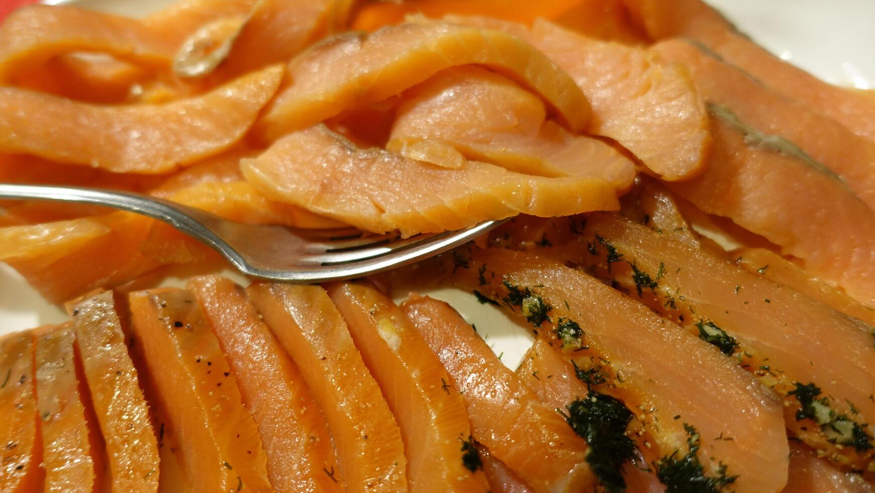 Seasoned and smoked salmon fillet sliced and served photo