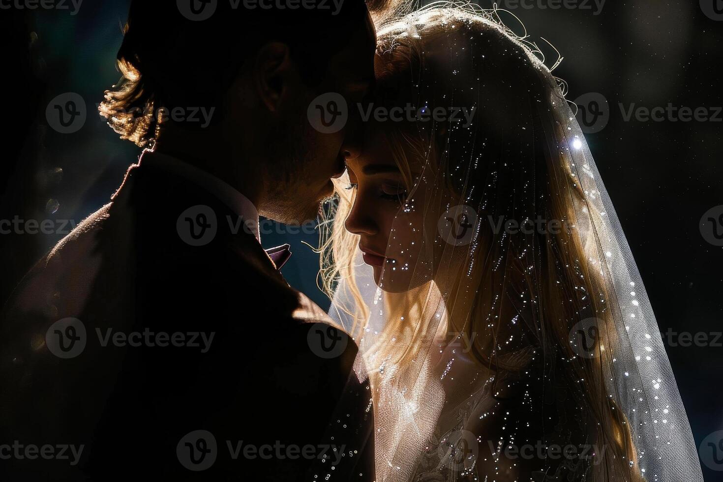 Wedding of a man and a woman. They hug and pose for a photo. Warm colors, dark background. Mysterious atmosphere photo