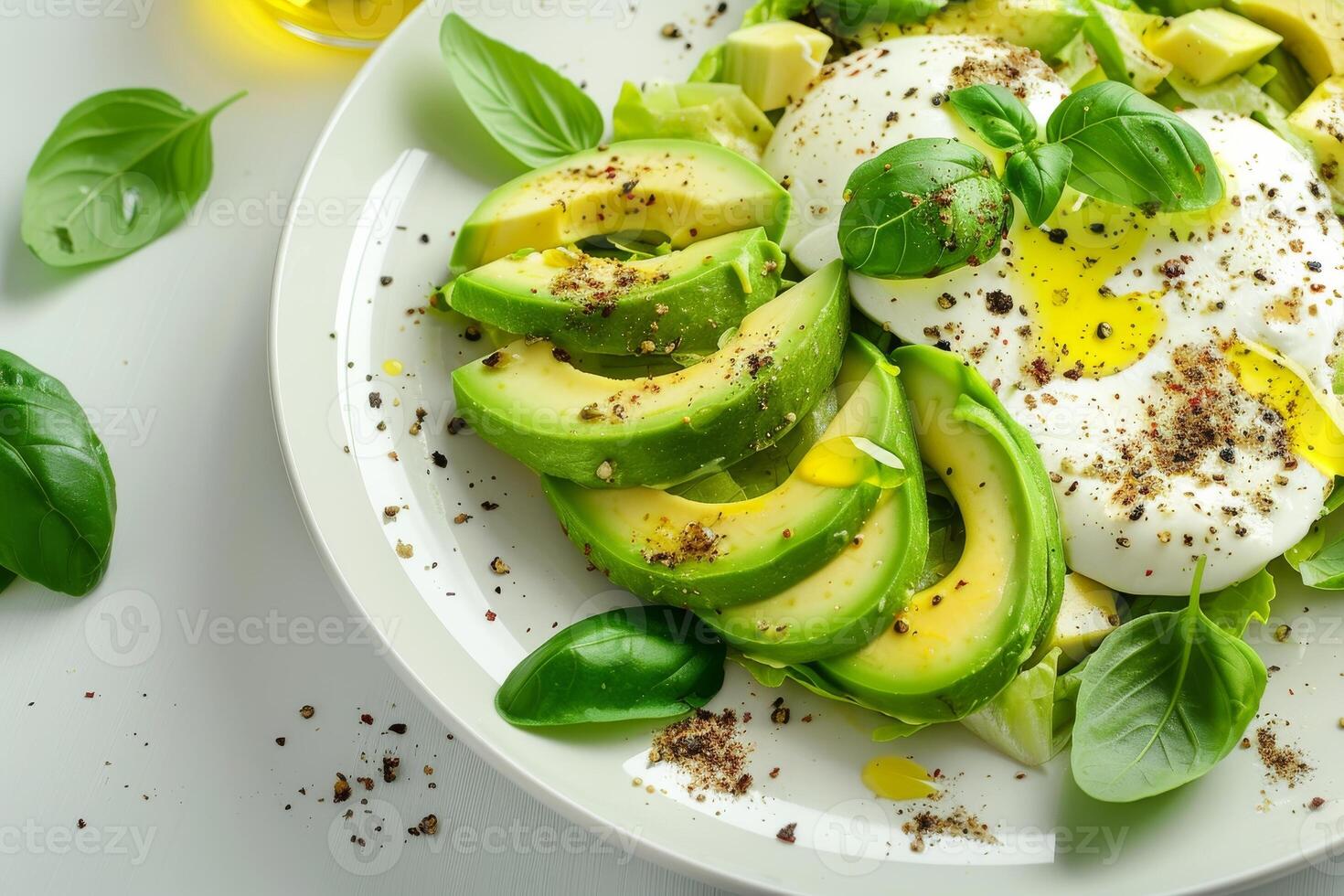 Macro frame of salad with avocado, mozzarella, olive oil, spices and basil on white background photo