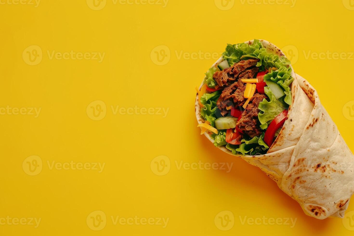 Large meat shawarma on a yellow background. Copy space photo