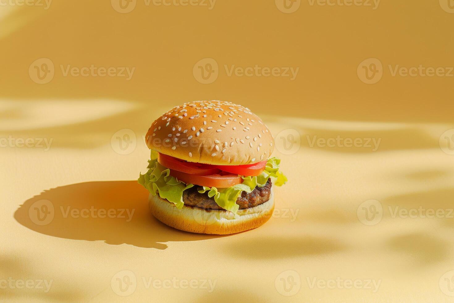 Small meat burger on a yellow background with empty space photo