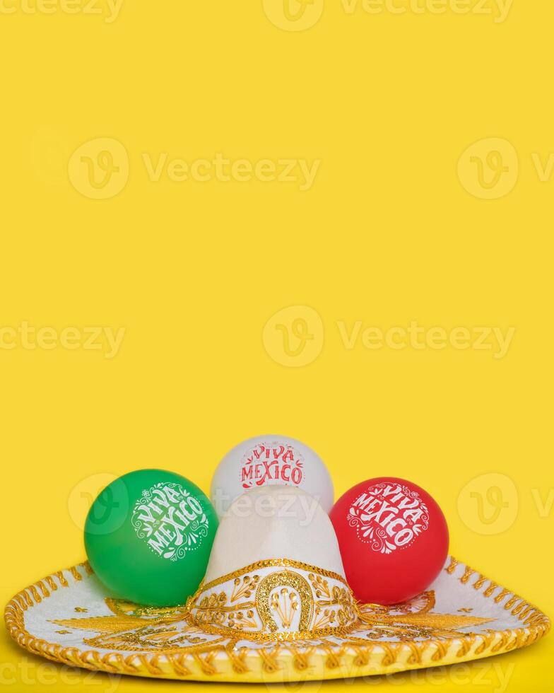 Mexican mariachi hat and balloons with text Viva Mexico, yellow background. Festive background, Cinco de Mayo, Mexican Independence Day. photo