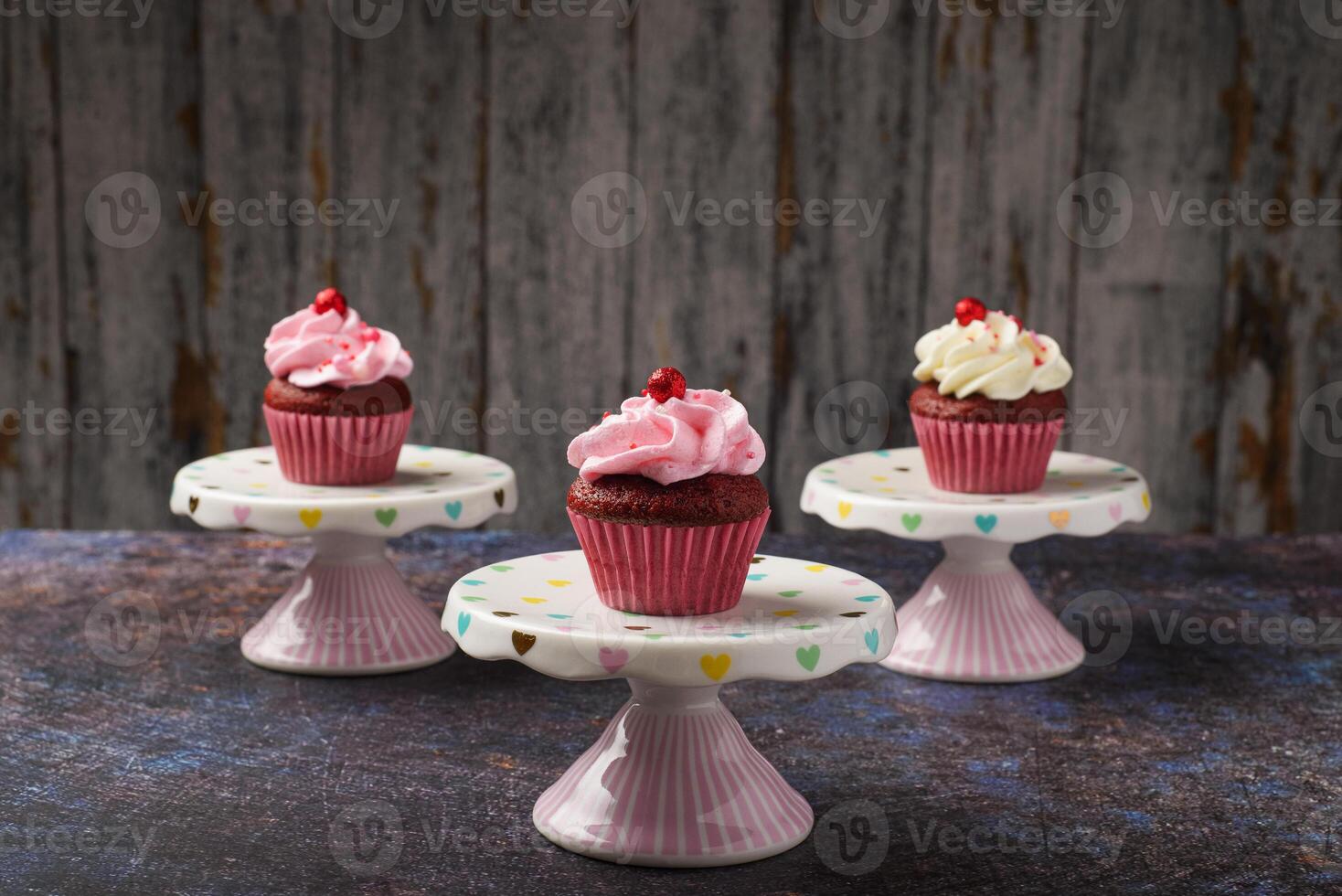 Cupcakes on small ceramic plate with wooden bottom with copy space. Product photo. photo