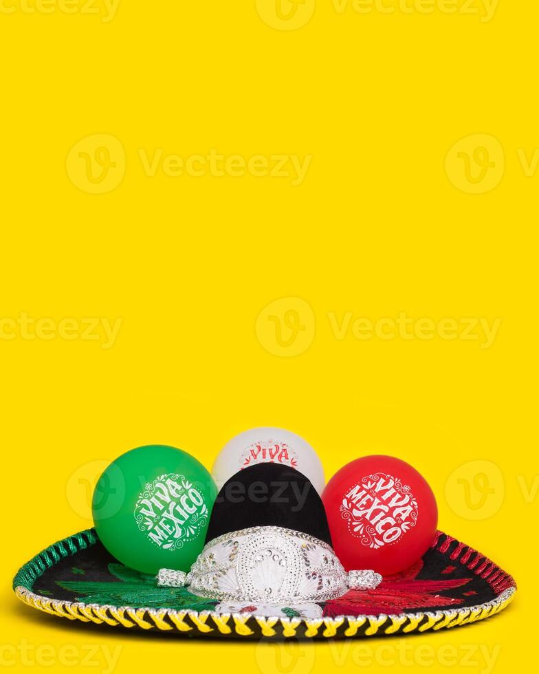 Mexican mariachi hat and balloons with text Viva Mexico, yellow background. Festive background, Cinco de Mayo, Mexican Independence Day. photo