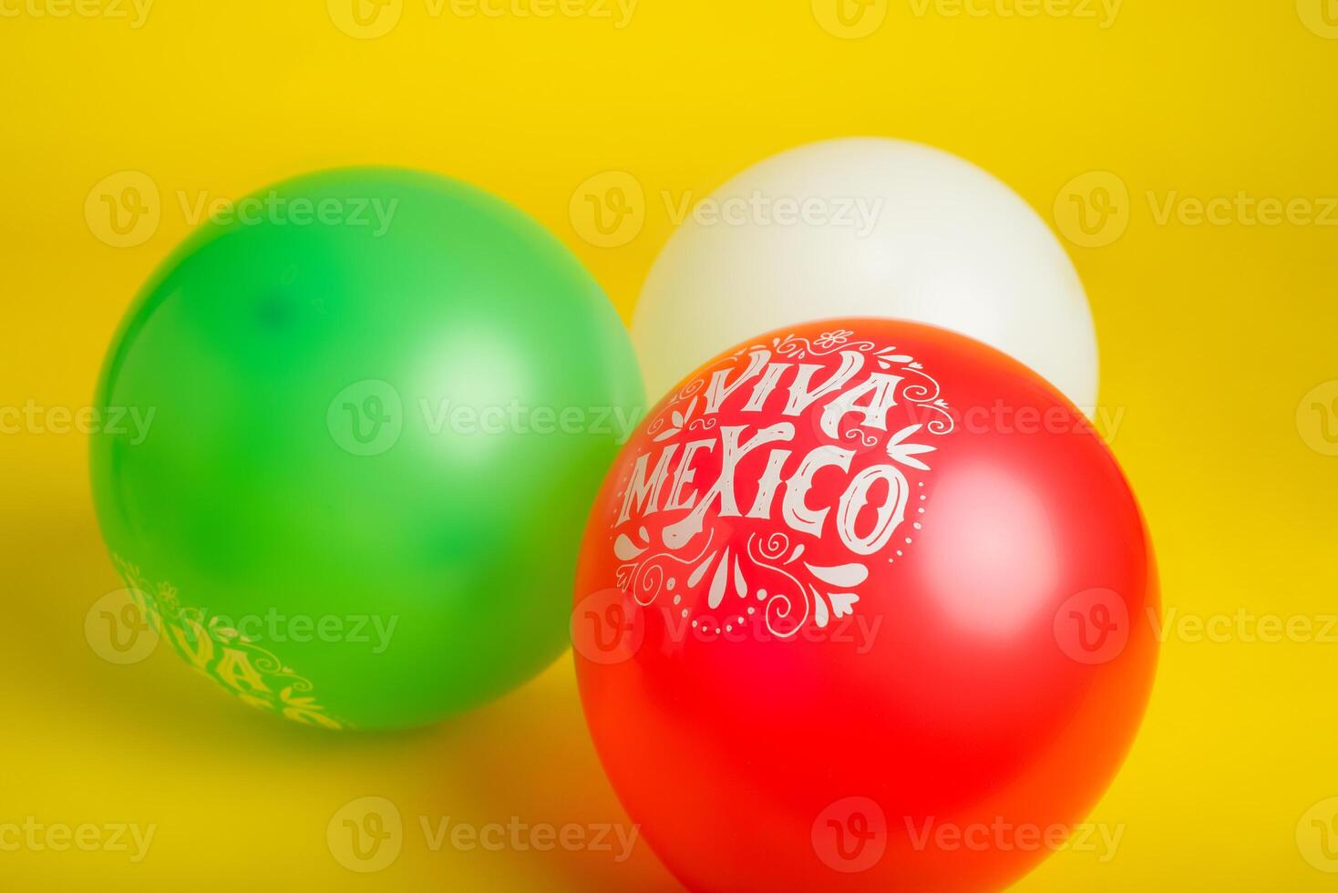 Balloons with Mexican flag colors and text Viva Mexico on yellow background. Cinco de Mayo festive background. photo