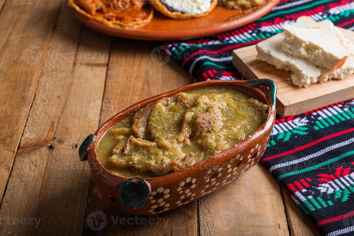 Chicharrones in green sauce, typical mexican food. Mexican food in clay pot. photo