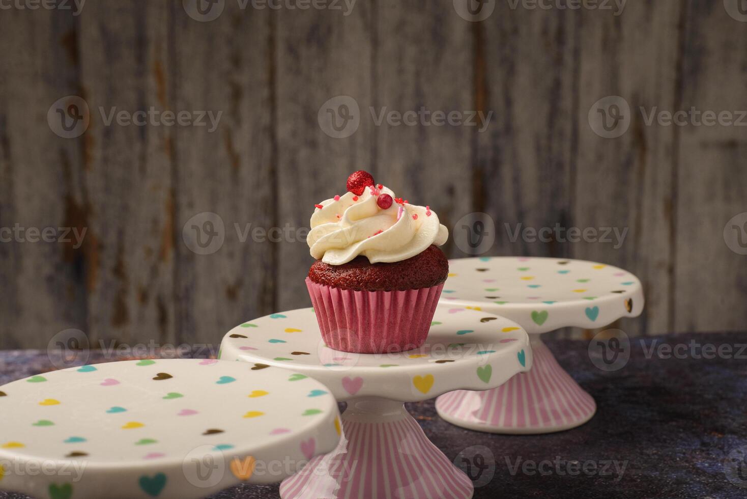 Cupcake on small ceramic plate with wooden bottom with copy space. Product photo. photo