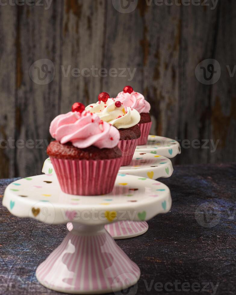 Cupcakes on small ceramic plate with wooden bottom with copy space. Product photo. photo