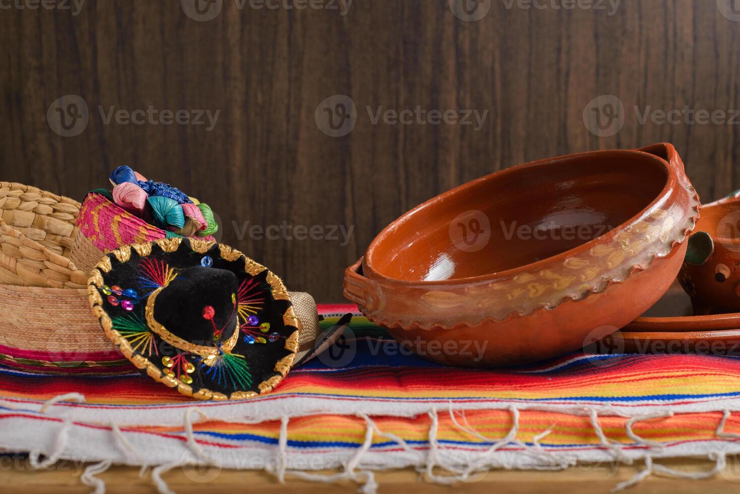 Clay pots, Mexican handicrafts and serape with wooden background. Cinco de mayo celebration background. photo