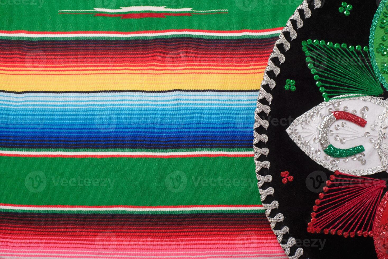 Mariachi hat on colorful serape. Mexican sombrero. Cinco de mayo background. photo