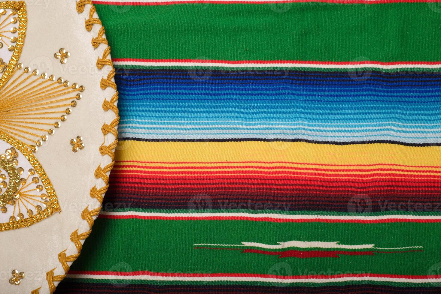 Mariachi hat on colorful serape. Mexican sombrero. Cinco de mayo background. photo