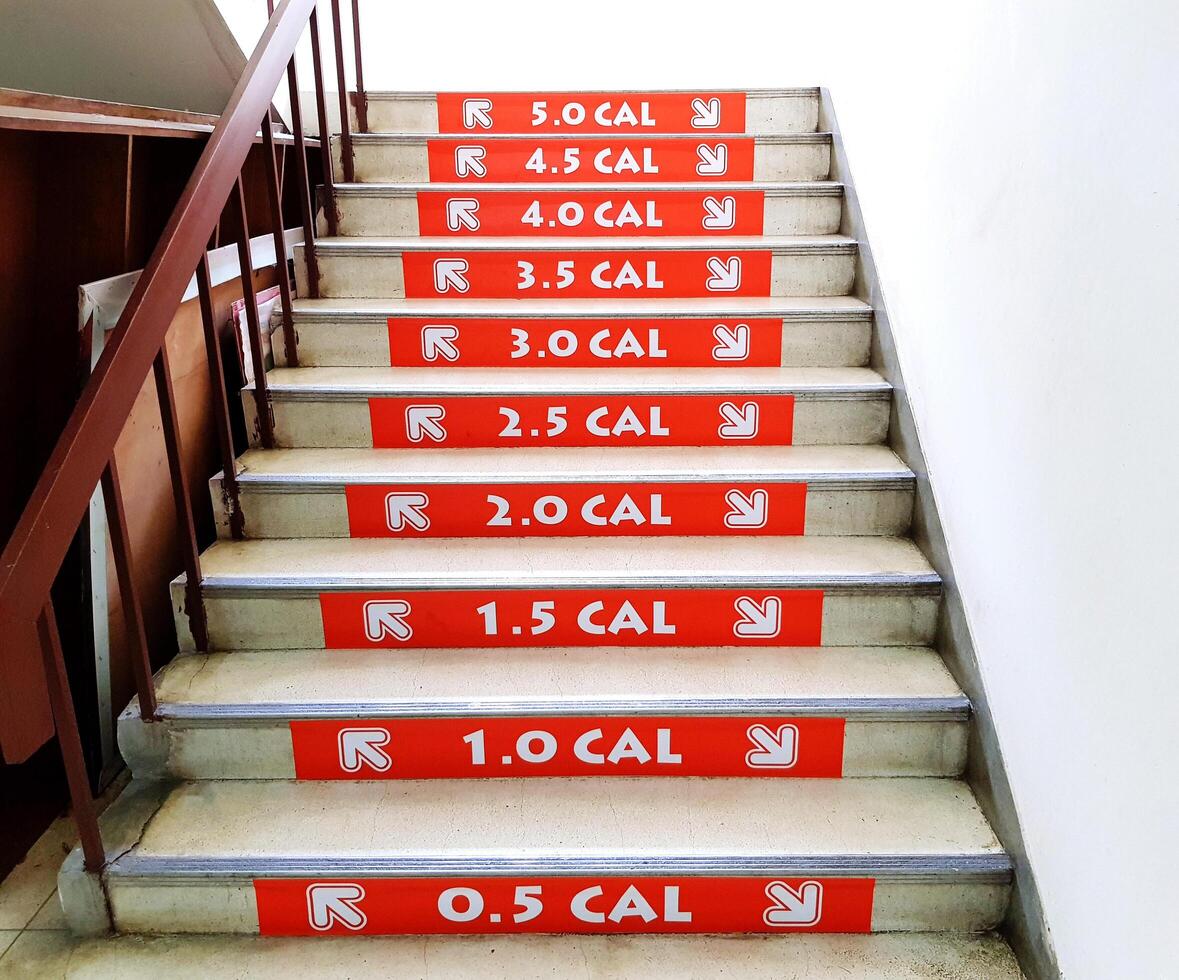 Orange number of waste calories when people going up and going down staircase. Healthy care and Exercise concept photo