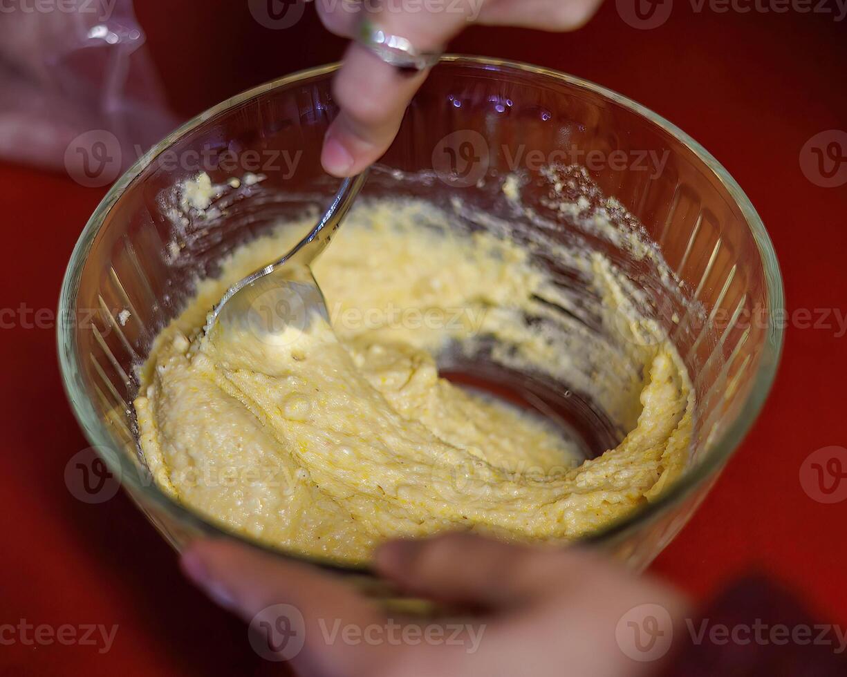 a bowl of vegetarian cornbread batter being mixed up to be spooned into cupcake papers photo