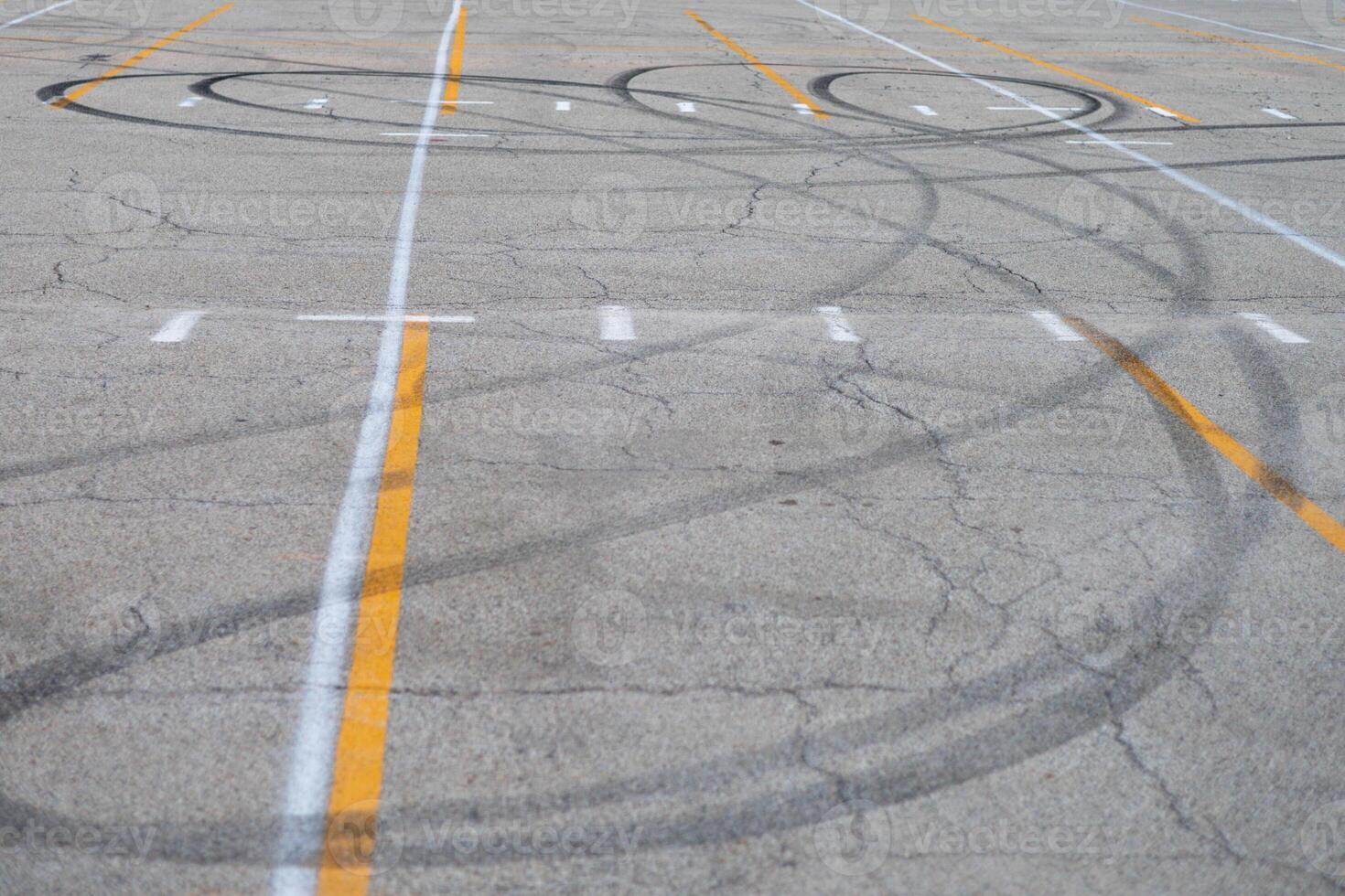 looping car tracks in the middle of a parking lot photo