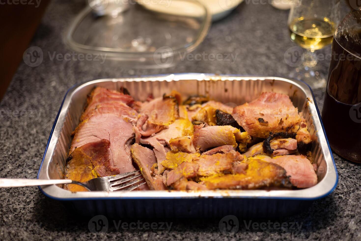 roasted ham in a pan all ready for serving at a family gathering photo