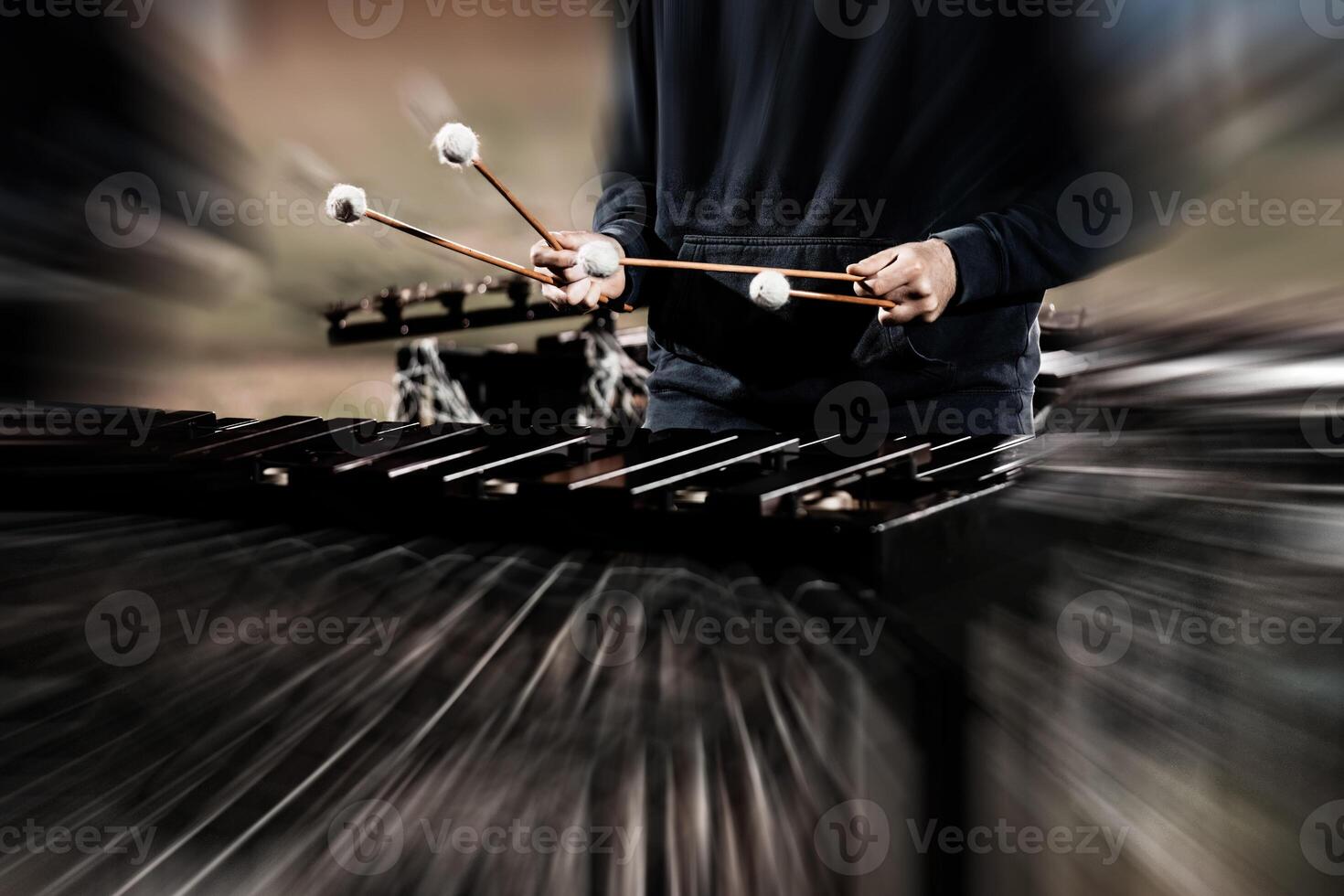 a percussionist rehearsing for a marching band show one autumn evening photo