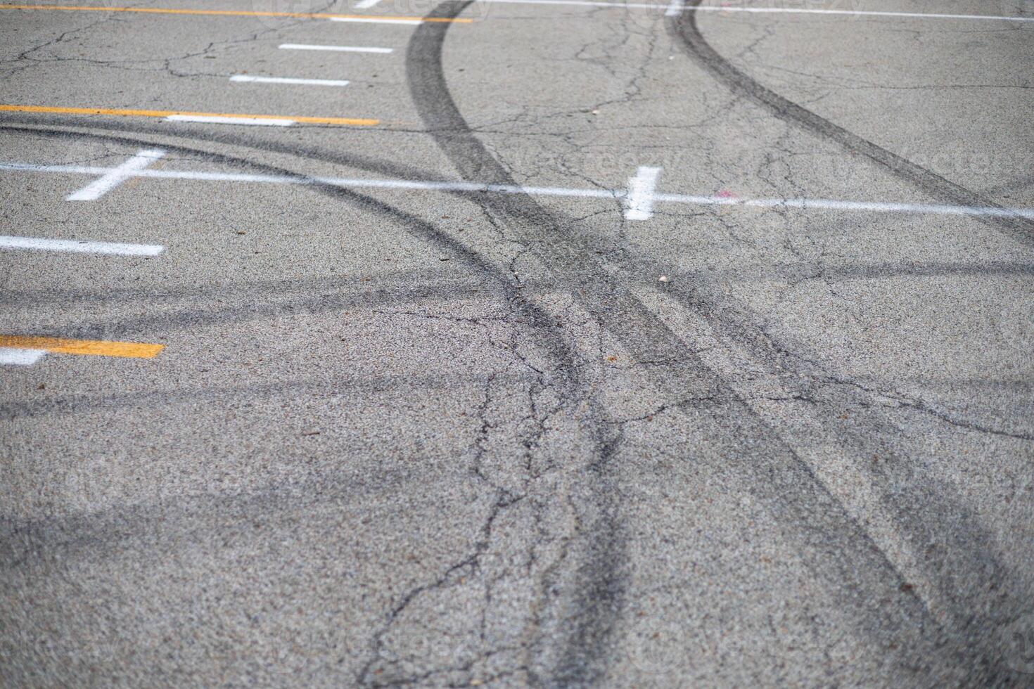 black car tracks in the middle of a parking lot photo