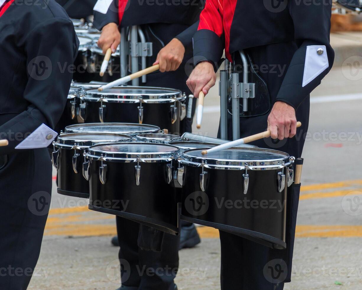 snare section of a marching band drum line warming up for a parade photo