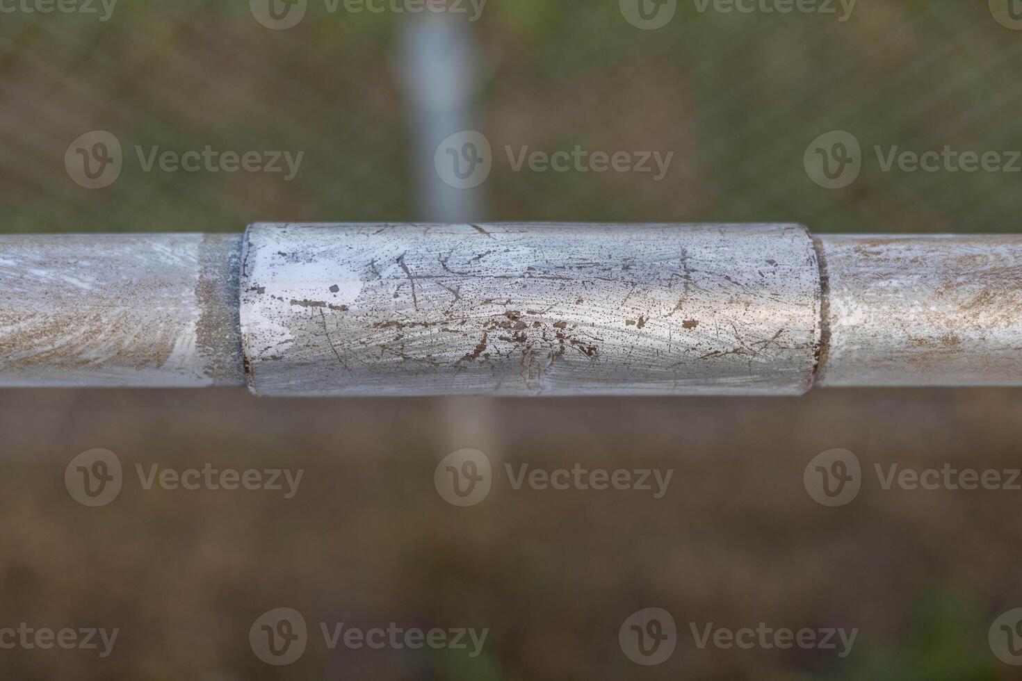 a repaired section of hand railing on the front section of some bleachers photo