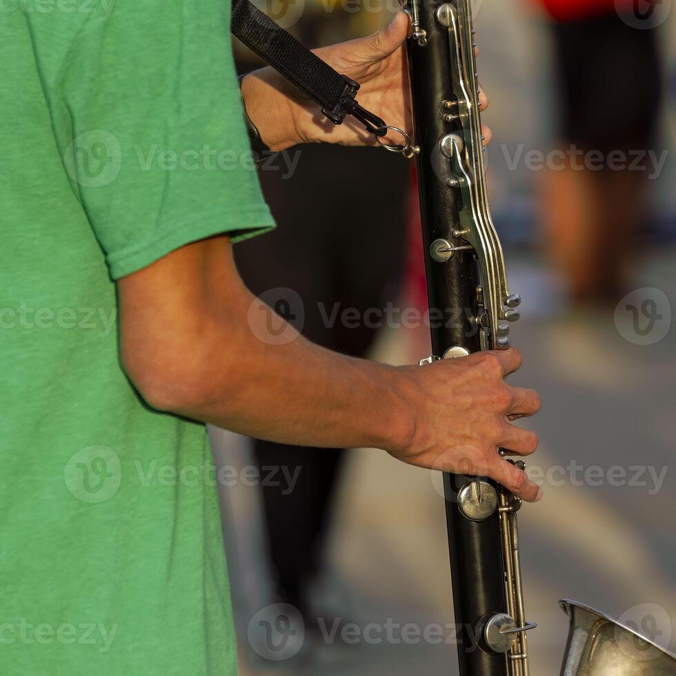 hands of a musician playing a clarinet at rehearsal photo