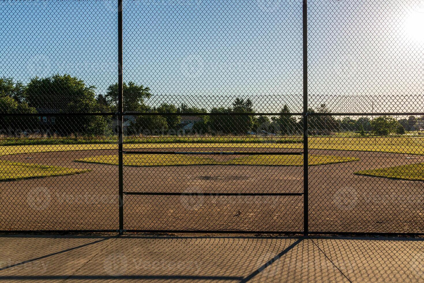 the infield of a baseball diamond in the early morning photo