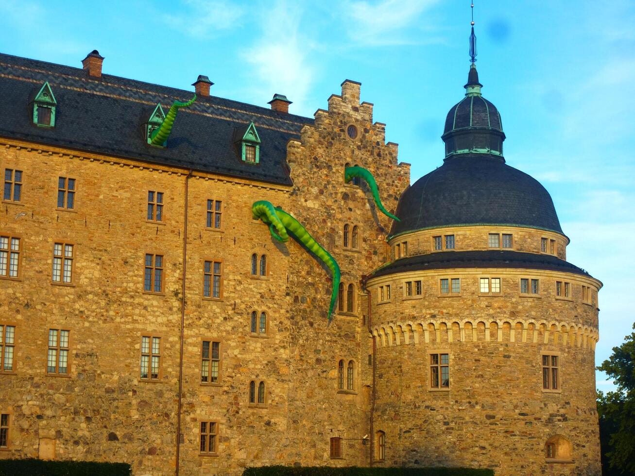 Facade of the ancient castle with dragons during the cultural festival. photo