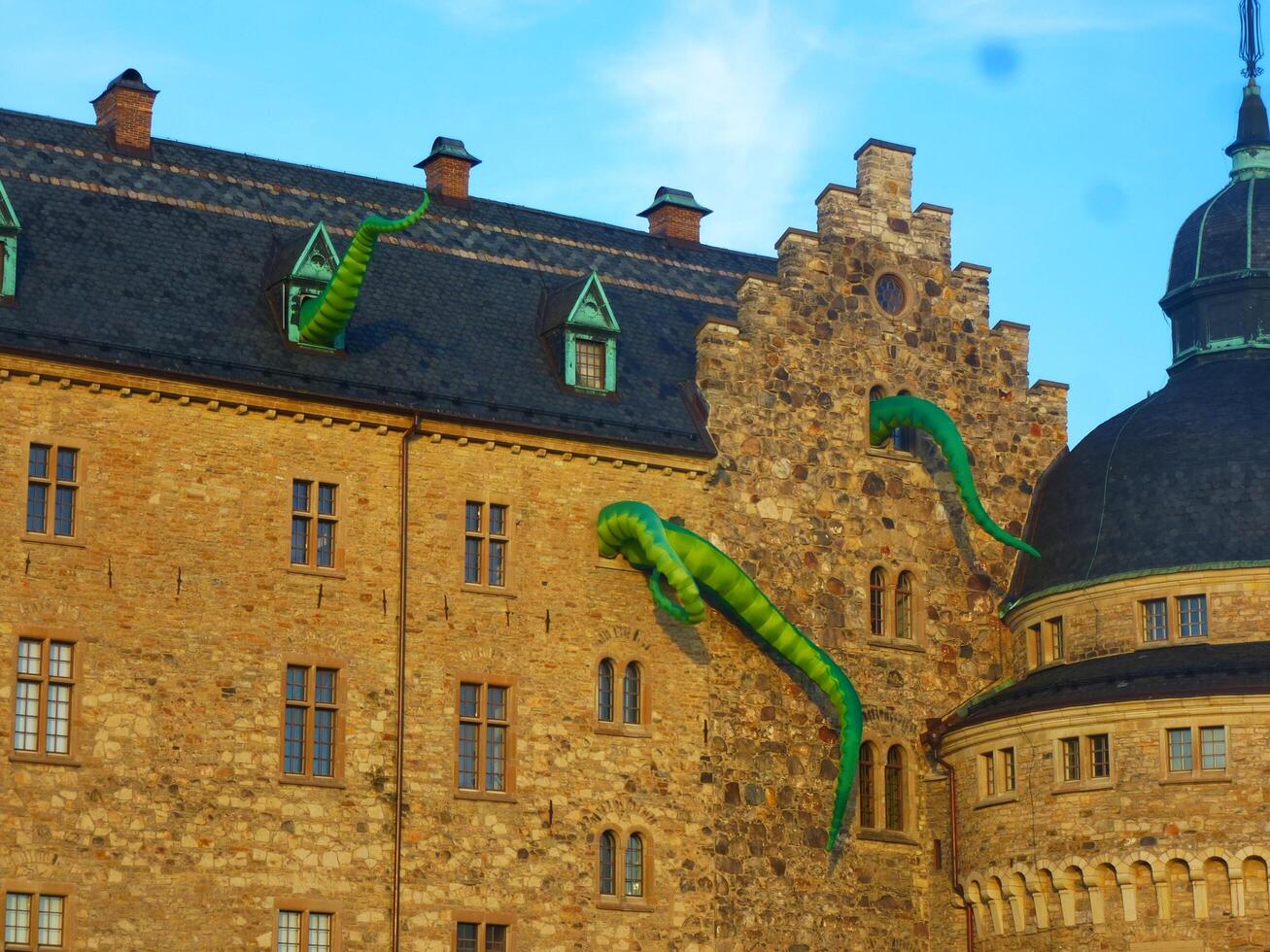 Facade of the ancient castle with dragons during the cultural festival. photo
