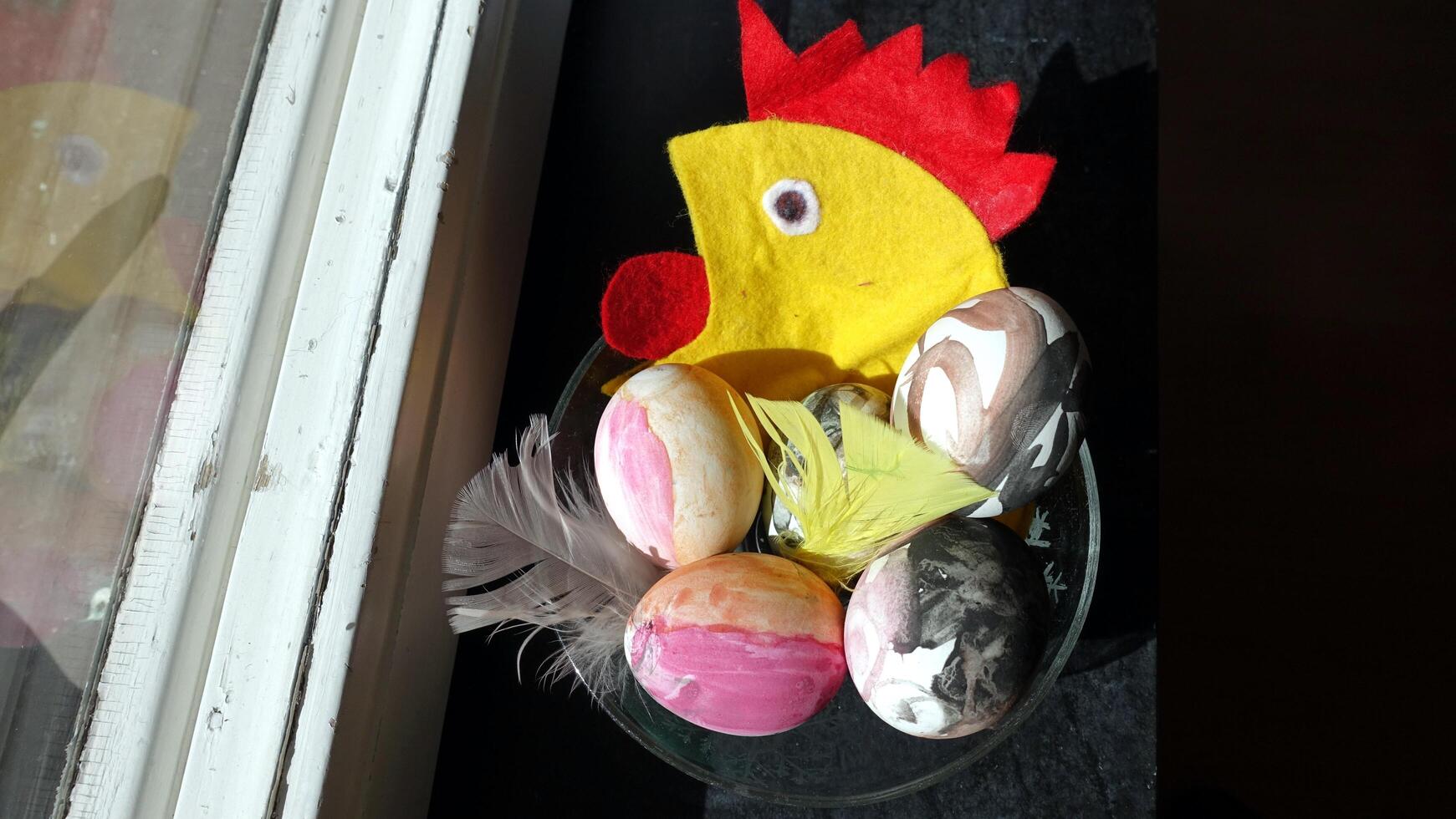 Eggs painted with a cloth hen in the background to wish everyone happy Easter photo