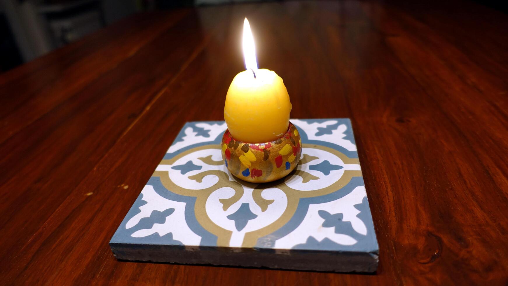 A lit egg-shaped candle to wish everyone happy Easter photo