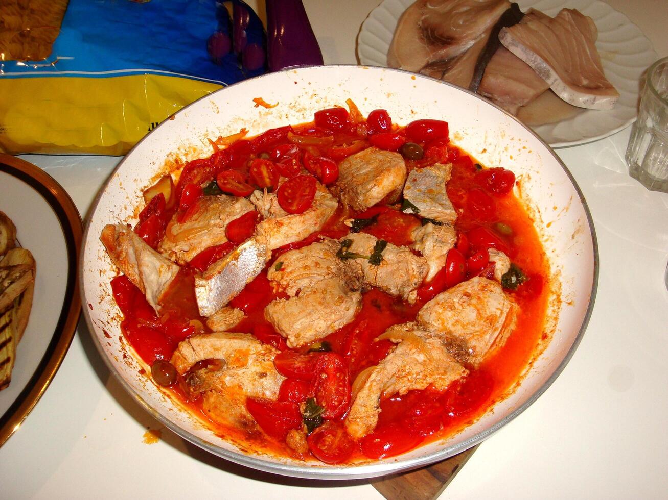 watercolorstyle representing a pan with fish fillets in tomato sauce ready to serve photo