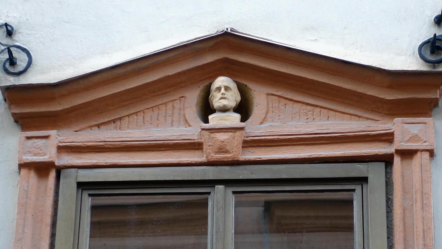 Facade of a historic building in central Stockholm. On the windows you can see the heads of characters from Italian history. photo